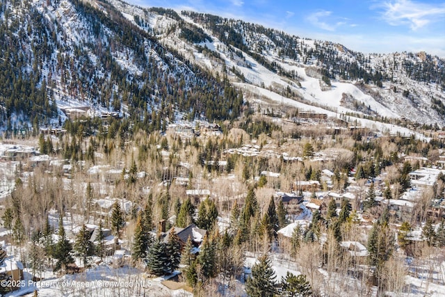 snowy aerial view with a mountain view