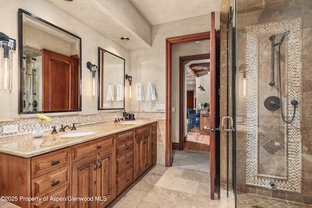 bathroom with double vanity, a sink, and a shower stall