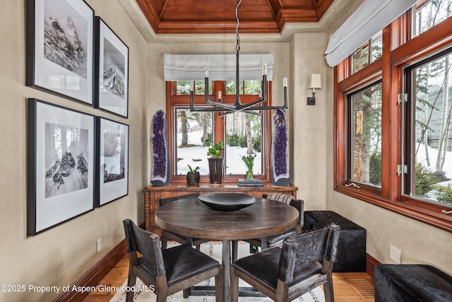 dining room featuring plenty of natural light, baseboards, and crown molding