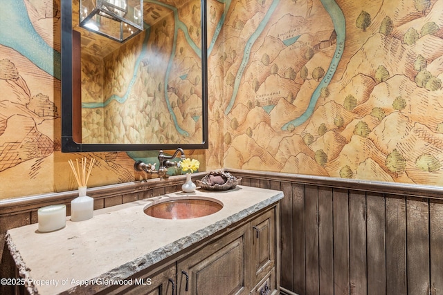 bathroom featuring a wainscoted wall and vanity