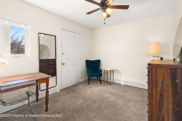 sitting room with ceiling fan, carpet floors, and a baseboard heating unit