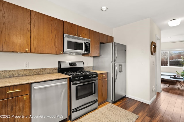 kitchen featuring stainless steel appliances and dark hardwood / wood-style floors