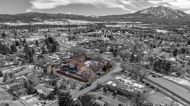 snowy aerial view with a mountain view