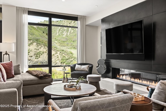 77 Wood Rd Unit 505E, Snowmass Village, CO 81615 - living room featuring recessed lighting and a glass covered fireplace