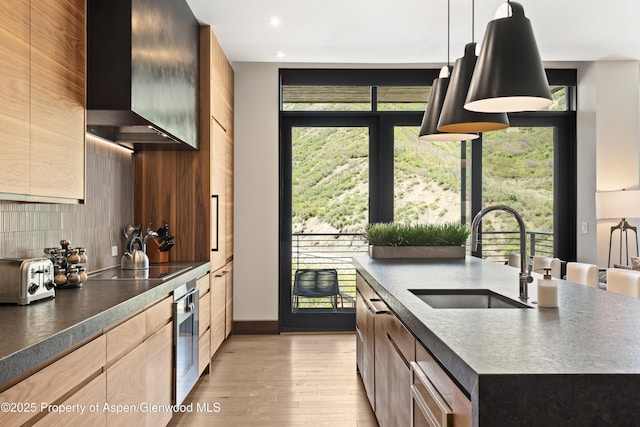 77 Wood Rd Unit 505E, Snowmass Village, CO 81615 - kitchen featuring a sink, wall chimney exhaust hood, dark countertops, modern cabinets, and recessed lighting