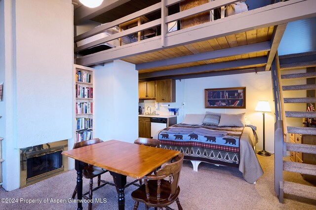 carpeted bedroom featuring beamed ceiling and wood ceiling