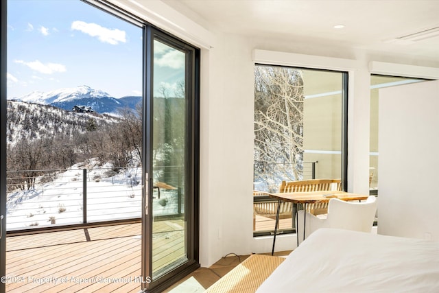 bedroom featuring a mountain view and access to exterior