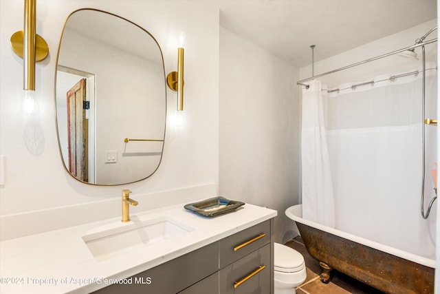 bathroom with a bathtub, toilet, and vanity