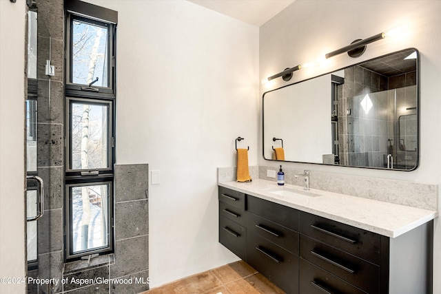 bathroom with tile patterned flooring, vanity, and a shower with shower door