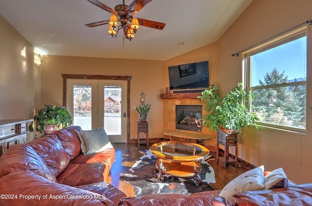 living room featuring ceiling fan, dark hardwood / wood-style flooring, and vaulted ceiling