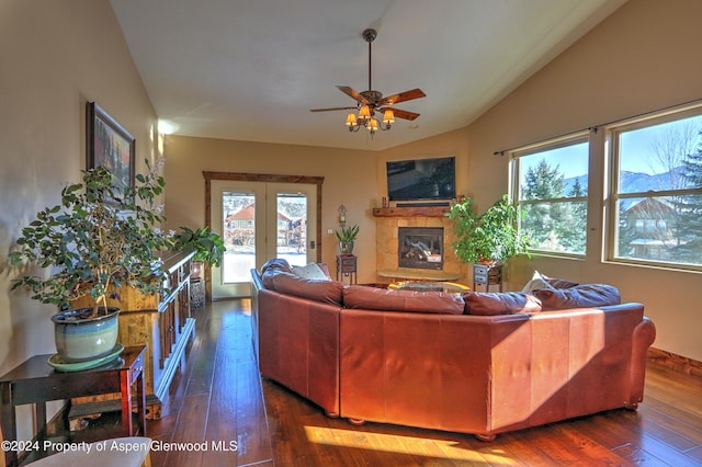 living room with lofted ceiling, ceiling fan, a fireplace, and dark hardwood / wood-style floors