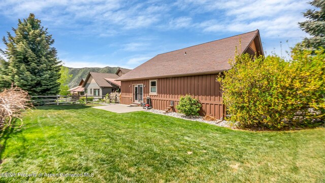 168 Blackhawk Dr, New Castle, CO 81647 - rear view of property featuring board and batten siding, a patio, and a shingled roof