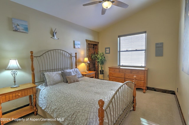 bedroom featuring ceiling fan, light colored carpet, and vaulted ceiling