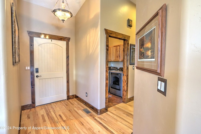 entryway featuring light hardwood / wood-style floors and independent washer and dryer