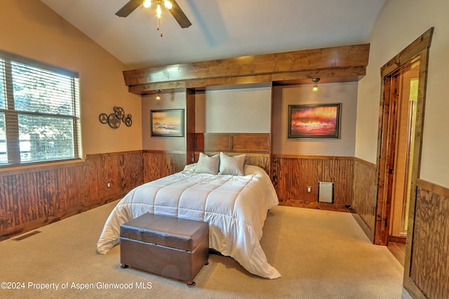 carpeted bedroom with ceiling fan and vaulted ceiling