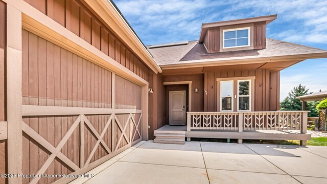 168 Blackhawk Dr, New Castle, CO 81647 - doorway to property with board and batten siding and a shingled roof