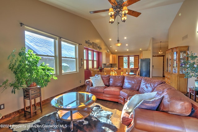 living room featuring ceiling fan, wood-type flooring, and high vaulted ceiling