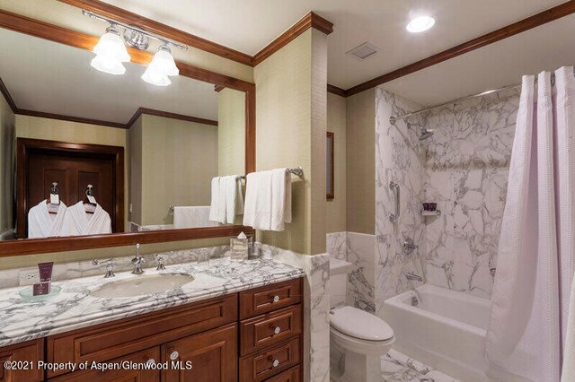 full bath with ornamental molding, shower / bath combination with curtain, vanity, and toilet