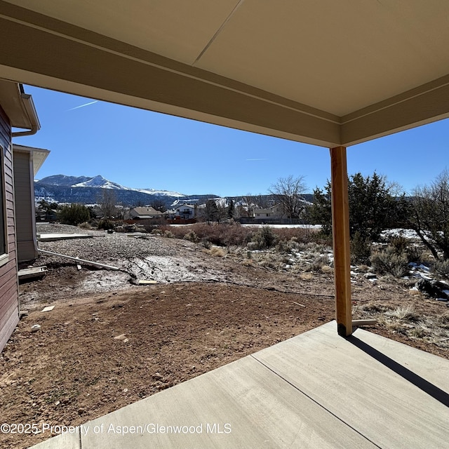 view of yard with a patio area and a mountain view