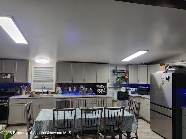 kitchen featuring stainless steel appliances, sink, and gray cabinets