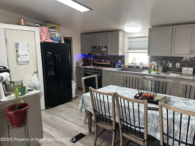 kitchen featuring gray cabinets, tasteful backsplash, appliances with stainless steel finishes, and sink