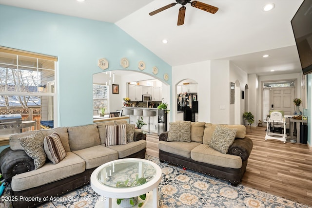 living room with hardwood / wood-style flooring, lofted ceiling, and ceiling fan