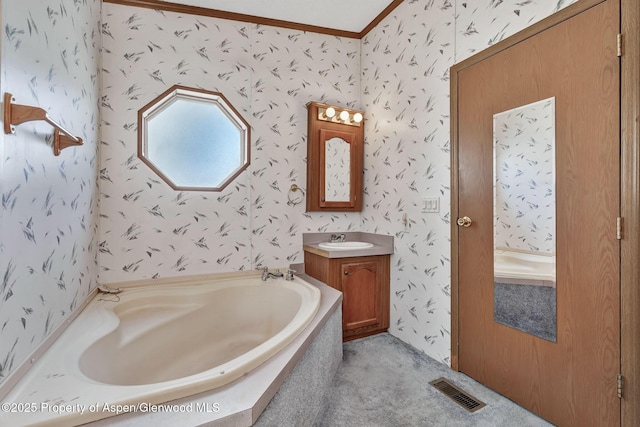 bathroom featuring wallpapered walls, visible vents, a garden tub, vanity, and crown molding