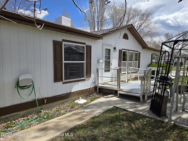 back of property featuring a chimney and a deck