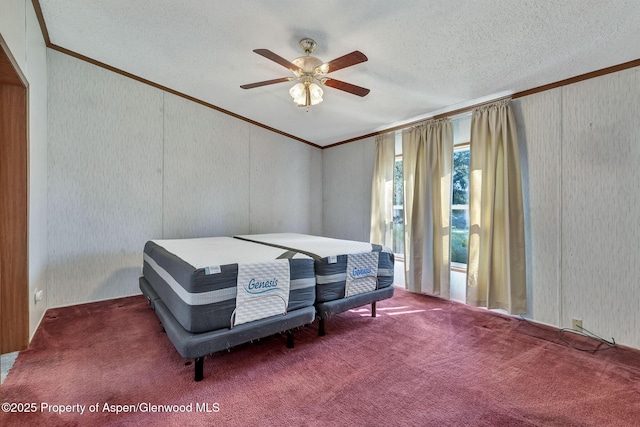 carpeted bedroom with ornamental molding, ceiling fan, and a textured ceiling