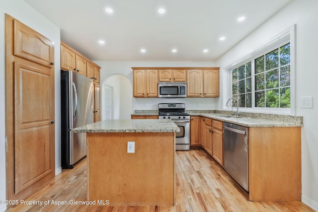 1020 Alta Vista Dr, Craig, CO 81625 - kitchen with appliances with stainless steel finishes, a center island, light stone countertops, light wood-style flooring, and recessed lighting