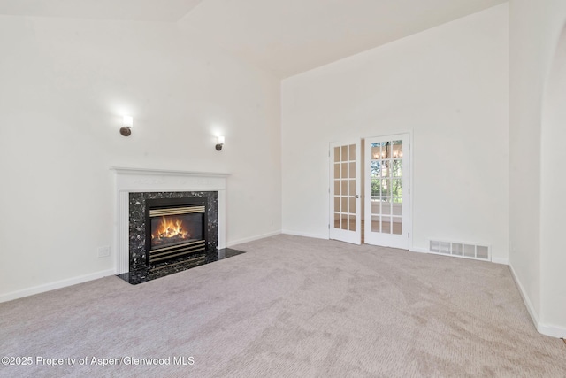 1020 Alta Vista Dr, Craig, CO 81625 - unfurnished living room featuring carpet, a premium fireplace, and high vaulted ceiling