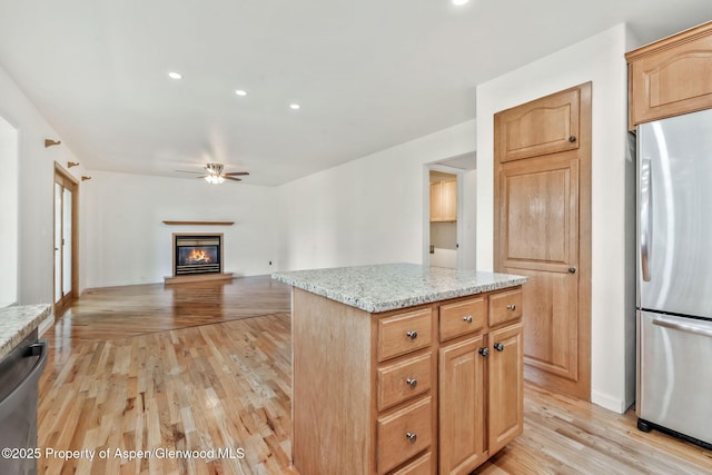 1020 Alta Vista Dr, Craig, CO 81625 - kitchen with appliances with stainless steel finishes, ceiling fan, light wood-style flooring, a center island, and light stone countertops