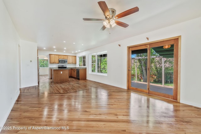 1020 Alta Vista Dr, Craig, CO 81625 - unfurnished living room with light wood-style floors, recessed lighting, a ceiling fan, and arched walkways