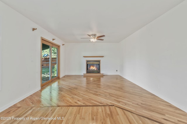 1020 Alta Vista Dr, Craig, CO 81625 - unfurnished living room featuring a ceiling fan, light wood-type flooring, and a glass covered fireplace