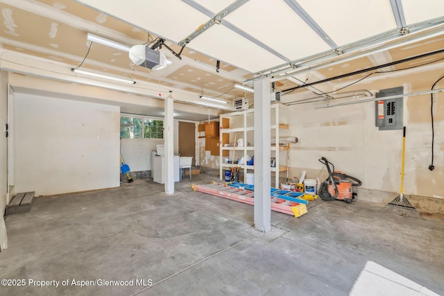 1020 Alta Vista Dr, Craig, CO 81625 - garage with electric panel, a garage door opener, and washer / clothes dryer