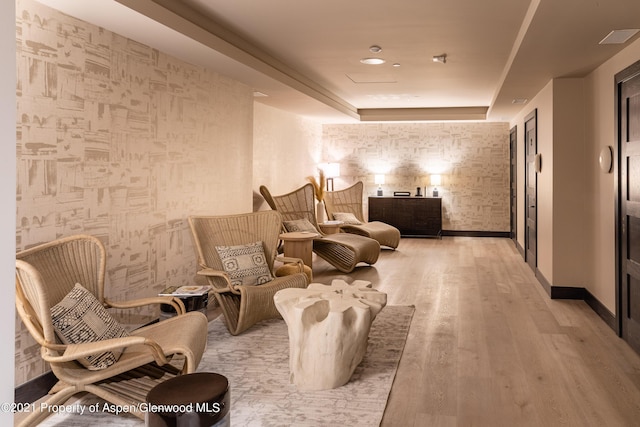 living area featuring light wood finished floors and baseboards