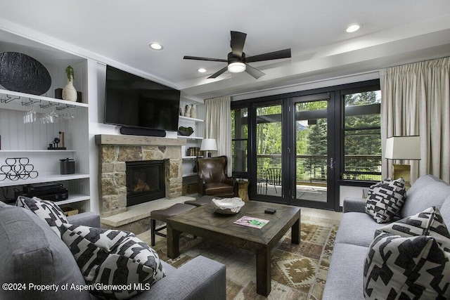 living area featuring recessed lighting, a stone fireplace, a ceiling fan, and wood finished floors