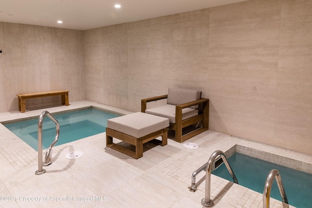 view of pool featuring a swimming pool and an indoor in ground hot tub