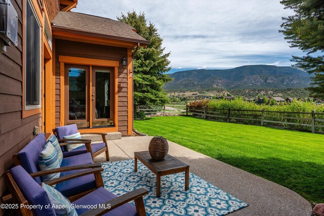 152 Blackhawk Dr, New Castle, CO 81647 - fenced backyard with a mountain view, french doors, and a patio