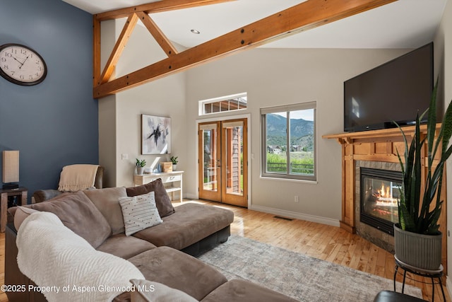 152 Blackhawk Dr, New Castle, CO 81647 - living room with hardwood / wood-style flooring, a fireplace, high vaulted ceiling, baseboards, and beamed ceiling