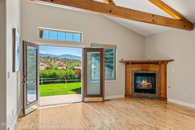 152 Blackhawk Dr, New Castle, CO 81647 - unfurnished living room featuring a mountain view, wood finished floors, beamed ceiling, plenty of natural light, and a fireplace