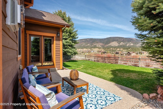 view of patio featuring fence and a mountain view