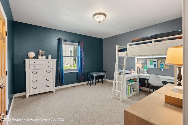 152 Blackhawk Dr, New Castle, CO 81647 - carpeted bedroom with a textured wall, an office area, and baseboards