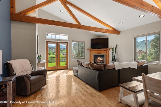 152 Blackhawk Dr, New Castle, CO 81647 - living area with beamed ceiling, high vaulted ceiling, a tiled fireplace, recessed lighting, and light wood-style flooring