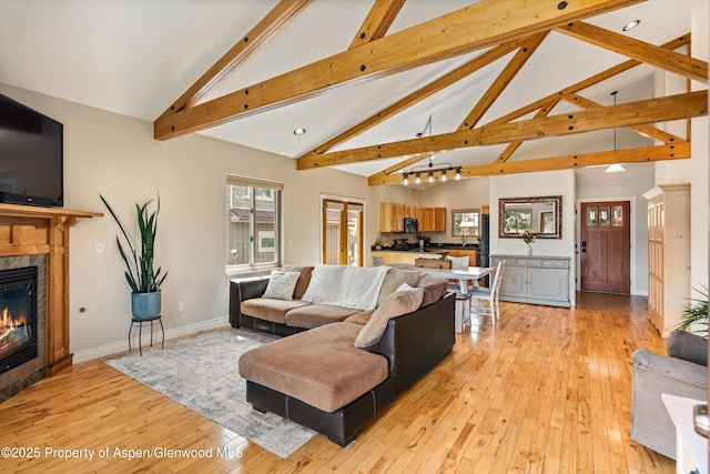 152 Blackhawk Dr, New Castle, CO 81647 - living area with light wood-style floors, beamed ceiling, high vaulted ceiling, a glass covered fireplace, and recessed lighting