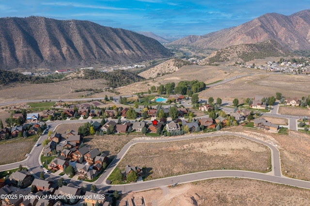 birds eye view of property with a mountain view and a residential view