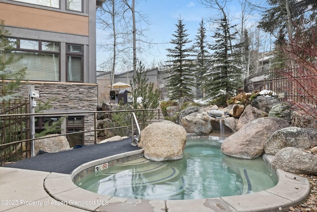 view of pool featuring fence