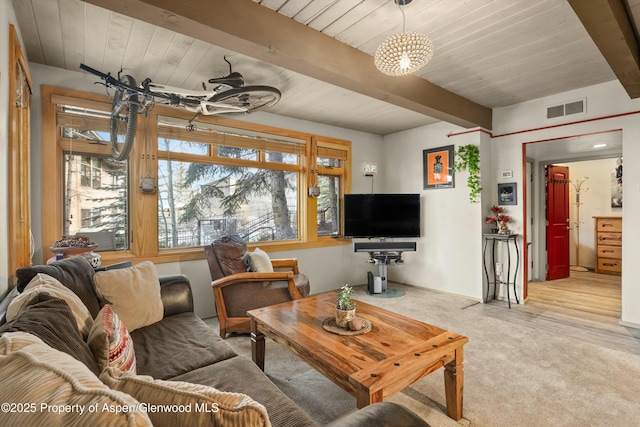 living area featuring wood ceiling, beam ceiling, carpet flooring, and visible vents