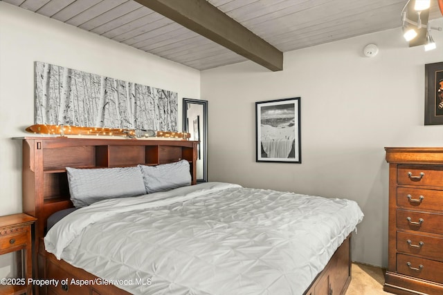 bedroom featuring wood ceiling, light carpet, and beam ceiling