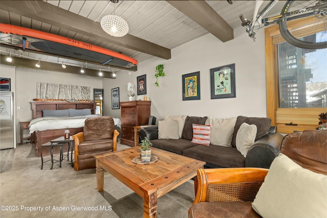 interior space with wooden ceiling, carpet flooring, beam ceiling, and track lighting